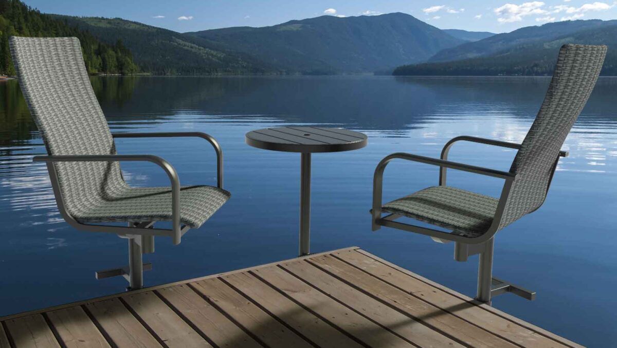 Two patio chairs and a table from Great Blue Dock Furniture placed on a floating dock overlooking mountains.