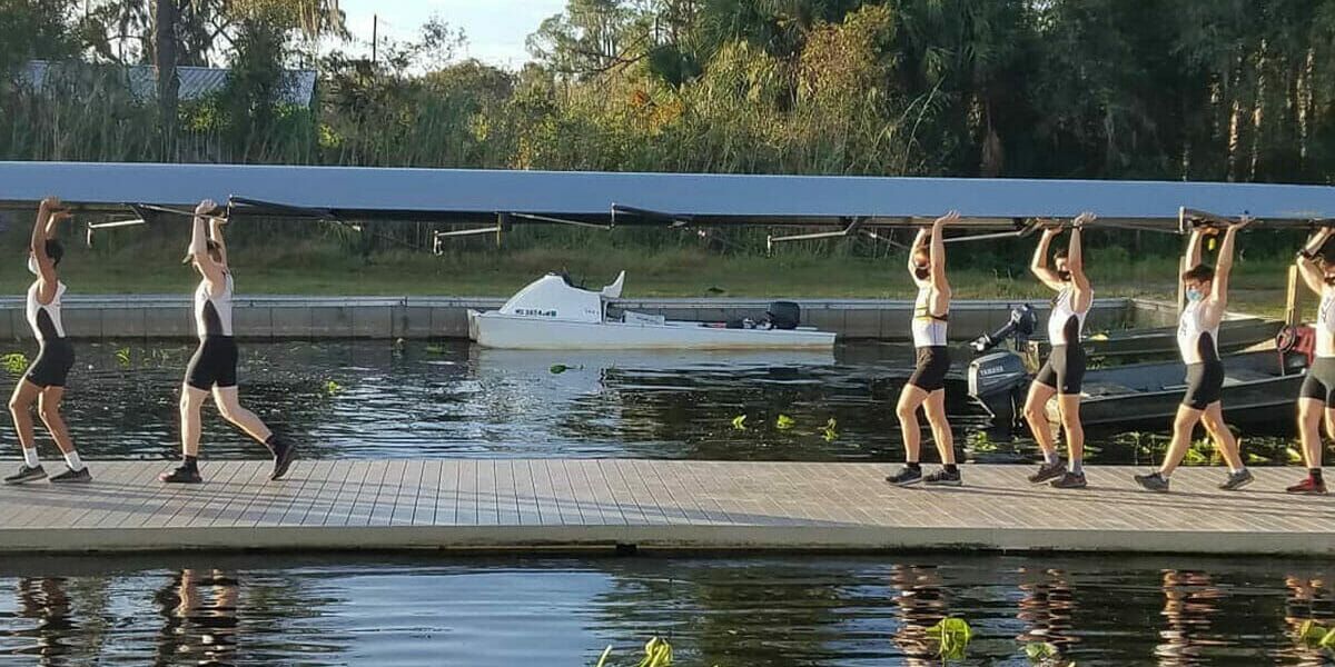 Men's Team Carrying Equipment to the Water
