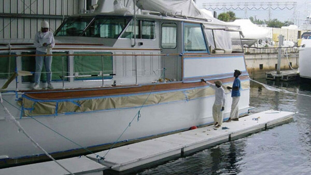 Employees on Floating Work Platforms working on a boat.