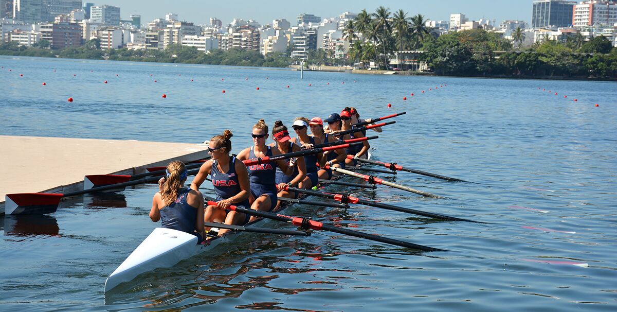 The womens USA rowing team pushes off a floating dock; a popular rowing athletic director investment.