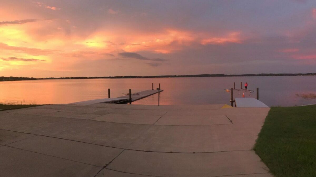 Rowing Starting Docks with a pink and orange sunset in the background.