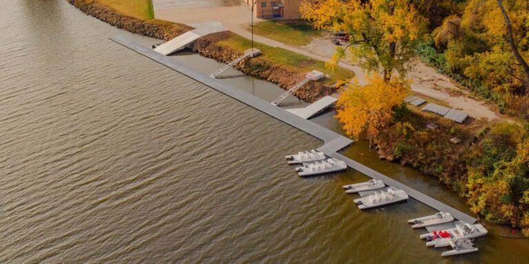 Aerial view of marina shoreline with modular floating docks and paddle boats showing dock layout ideas for public waterfront use