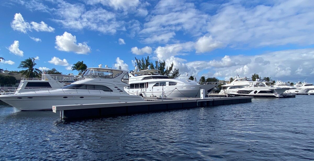 Yachts docked for people living on a boat in a marina.