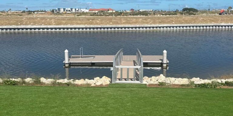 Floating dock with ramp leading to the water, shown as a calm waterfront setup ideal for new year dock upgrades.