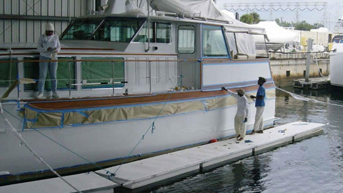 Employees on Floating Work Platforms working on a boat.