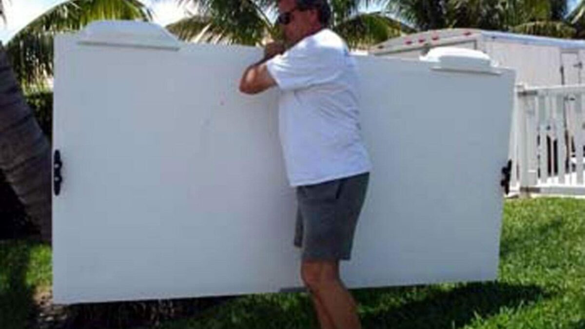 Man carrying his Floating Work Dock, showing how portable it is.