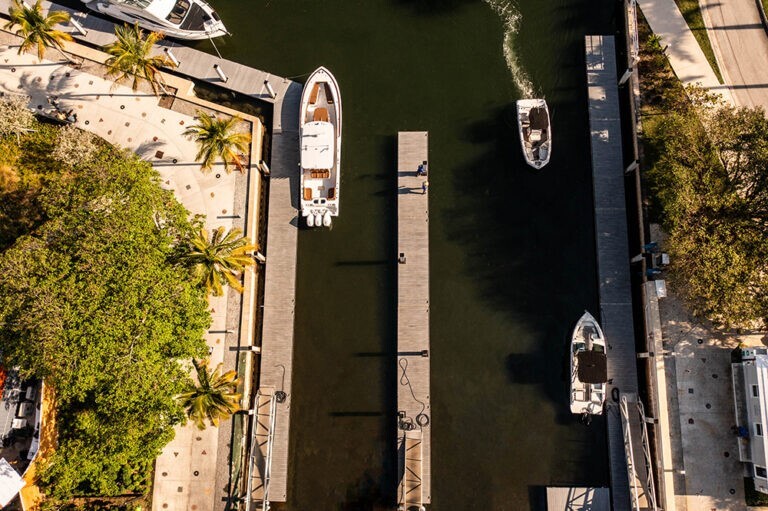 Luxurious boats float down the intercoastal to a bay of private marinas.