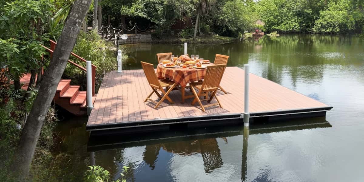Floating dock set with table and chairs for Thanksgiving dinner by the water, perfect setting for thanksgiving on the water celebration.